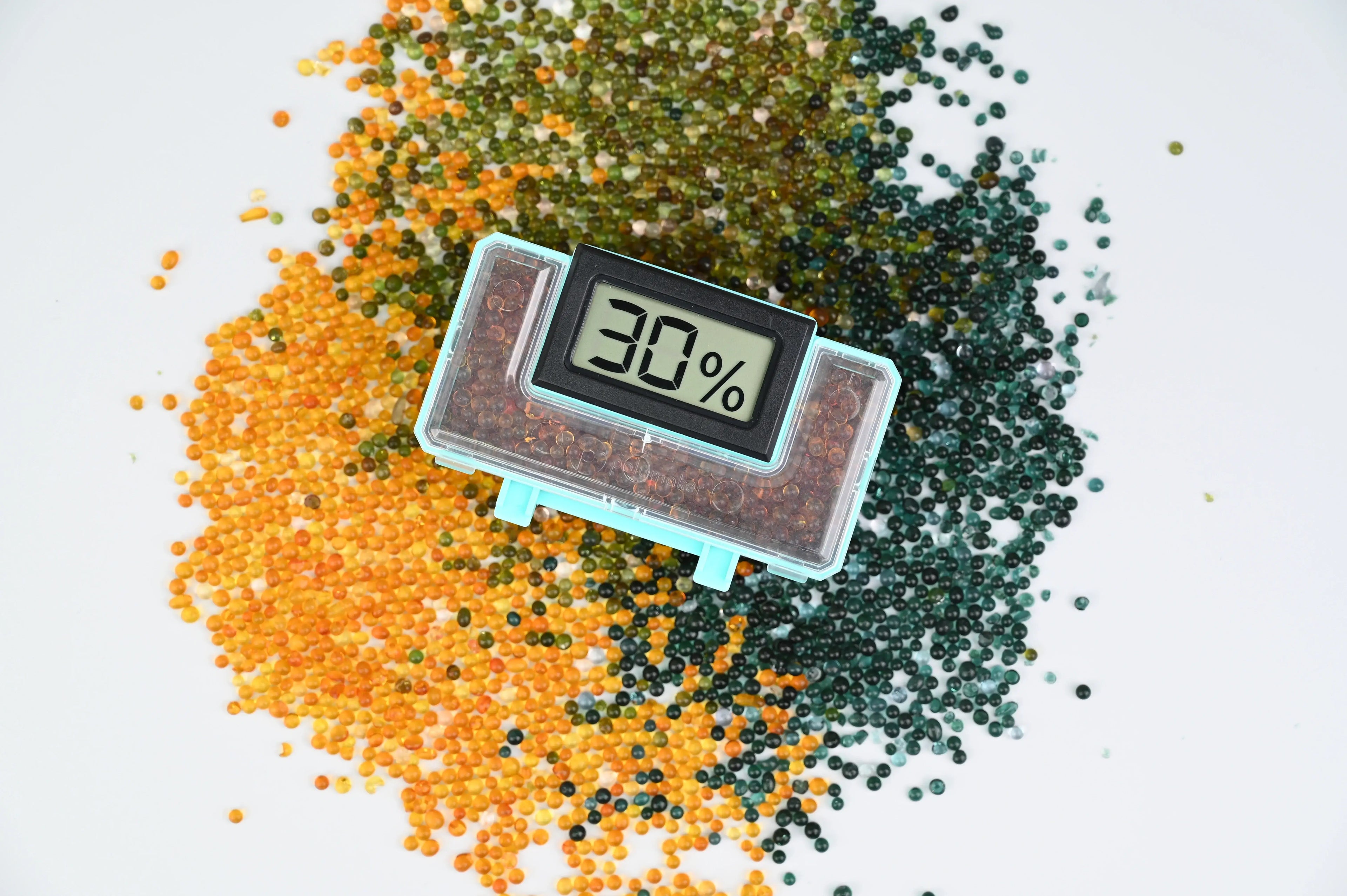 Polymaker PolyDryer™ Box with humidity gauge on colorful filament beads for 3D printing.